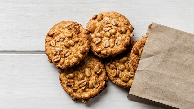 Paper bag with Delicious cookies on table