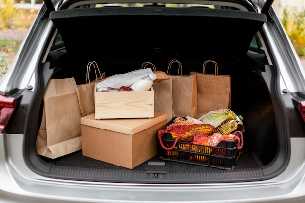 Paper bags and crates in car's trunk