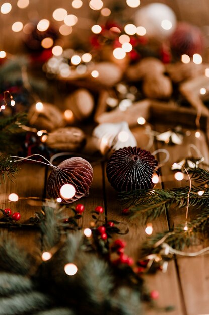 Paper ball garlands with Christmas lights on a wooden table