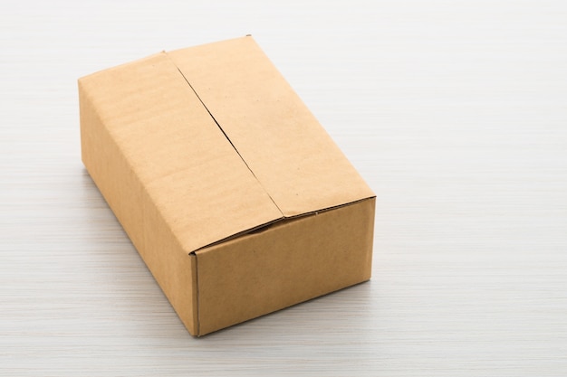 Free photo paper box on wood background