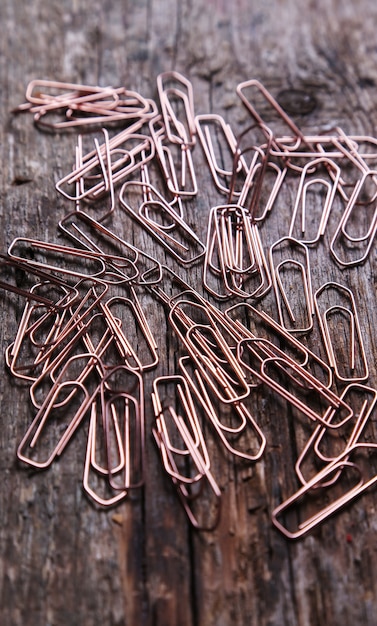 Free photo paper clip on a dark wood background