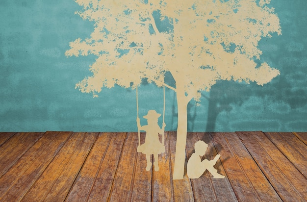 Paper cut of children read a book under tree