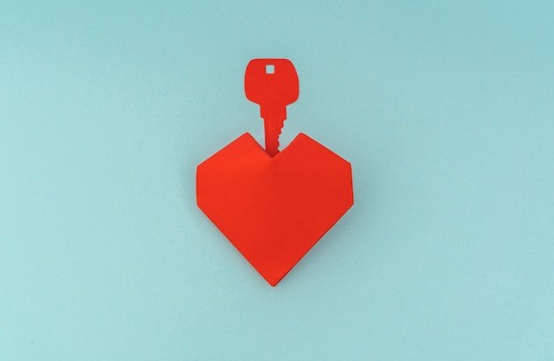 Free photo paper cut of key for heart as a symbol of love .