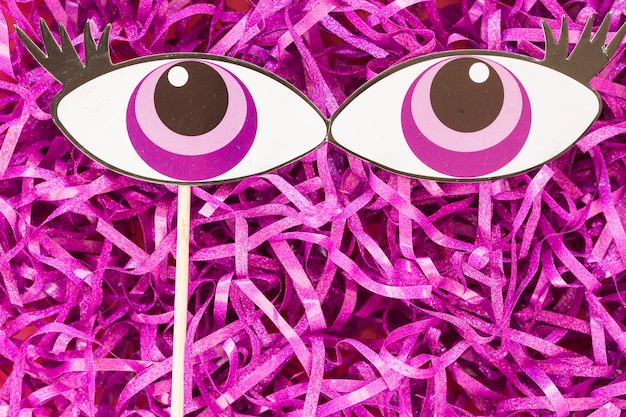 Free photo paper eyes on tinsel