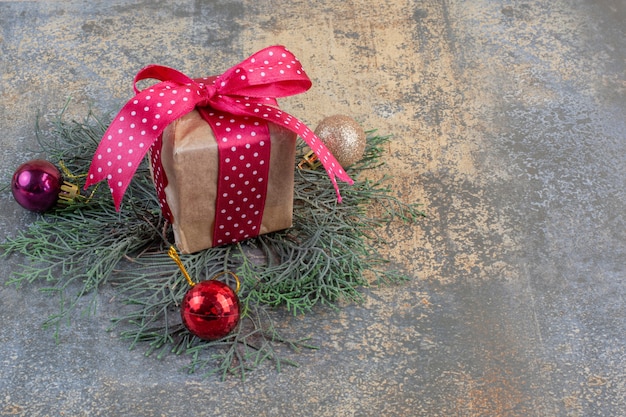 A paper gift box with bow and Christmas ball. High quality photo