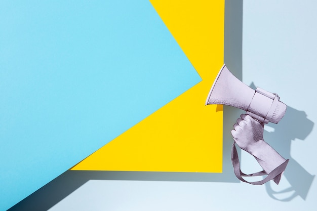 Paper hand holding megaphone