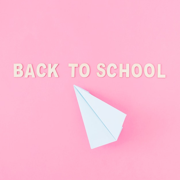 Free Photo paper plane near back to school writing