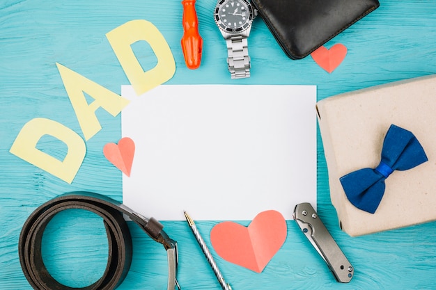 Free photo paper between red hearts and dad title near male accessories