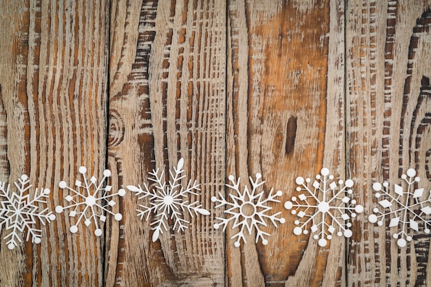 Paper snowflakes on wooden background