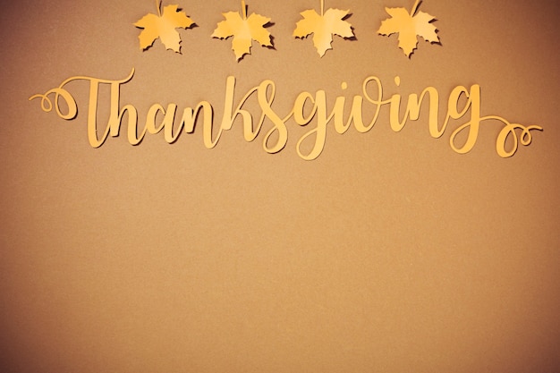 Free Photo paper thanksgiving lettering with small yellow leaflets