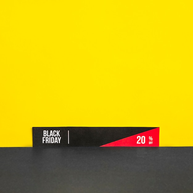 Free photo paper with black friday inscription on yellow background