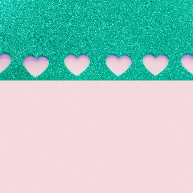 Free photo paper with small cut hearts on purple table