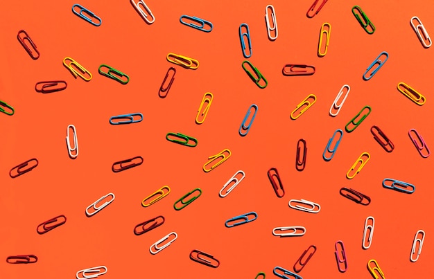 Paperclips on orange background