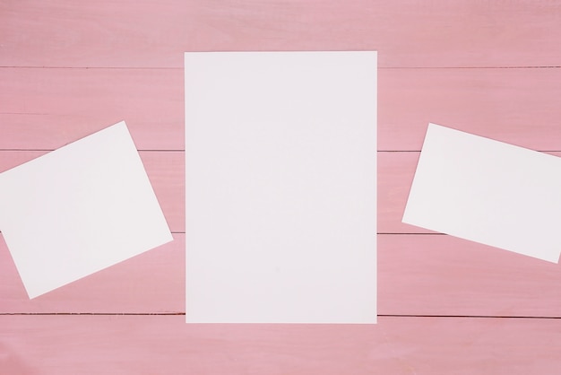 Free photo papers on pink wooden surface