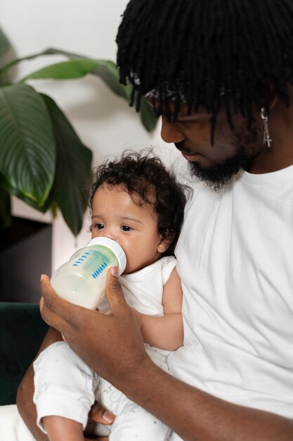 Parent feeding his kid in first years of life