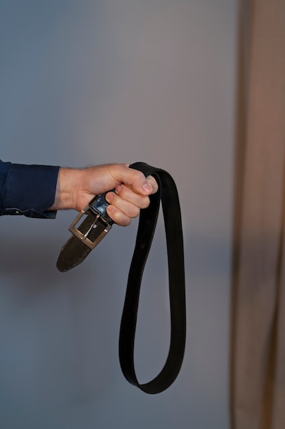 Free photo parent holding belt showing abuse towards children