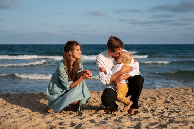 Parent with a baby on the beach at sunset