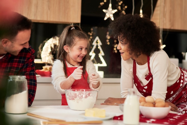 Parents and child baking cookies in the kitchen