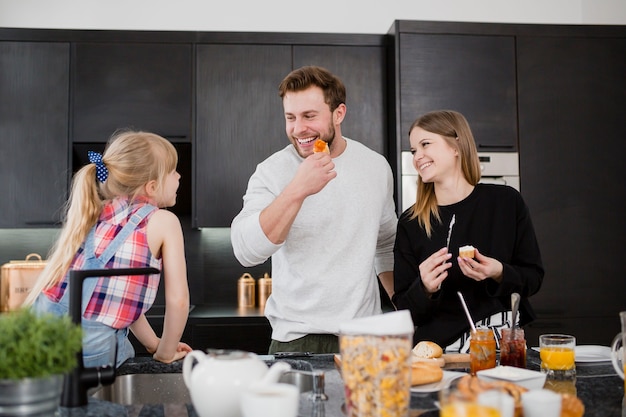 Parents cooking near daughter