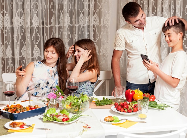 Parents enjoying their time with children at dinner table