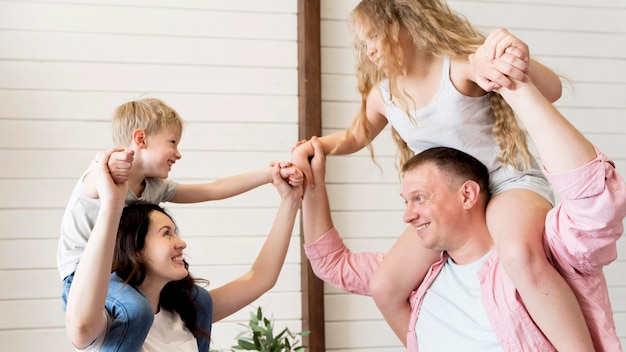 Parents holding kids on shoulders