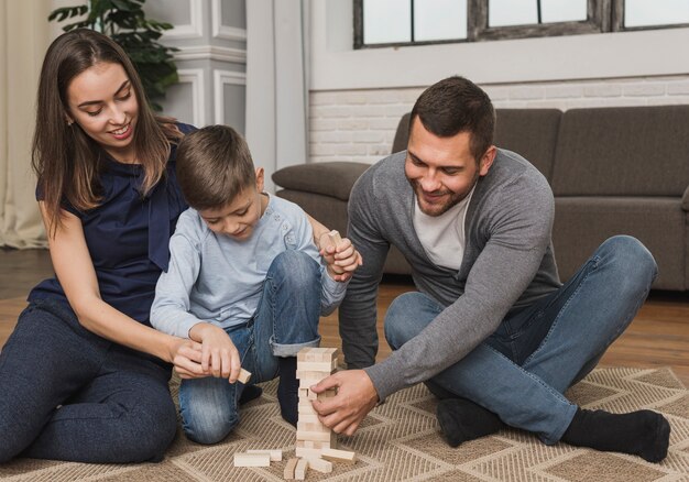 Parents playing jenga with child