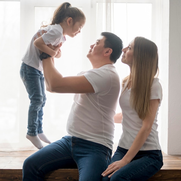 Parents playing with daughter