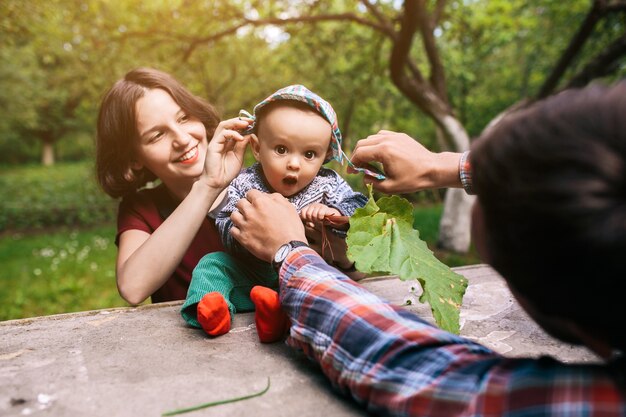 Parents putting hat on child