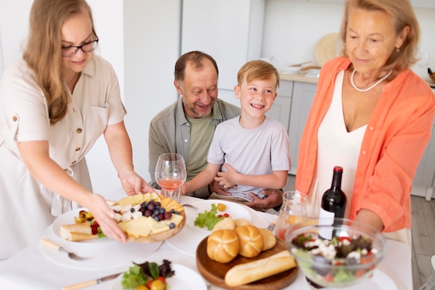 Free photo parents spending time with their daughter and grandson at home