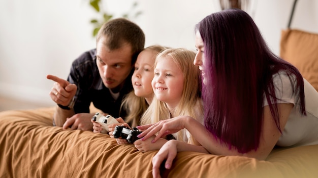 Free Photo parents teaching girls to play with joystick