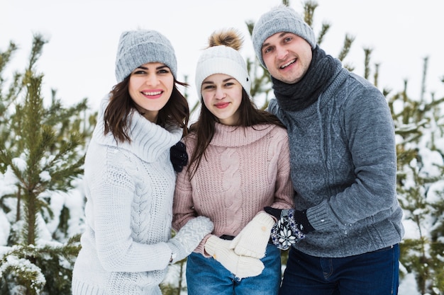 Parents and teenage daughter in winter forest