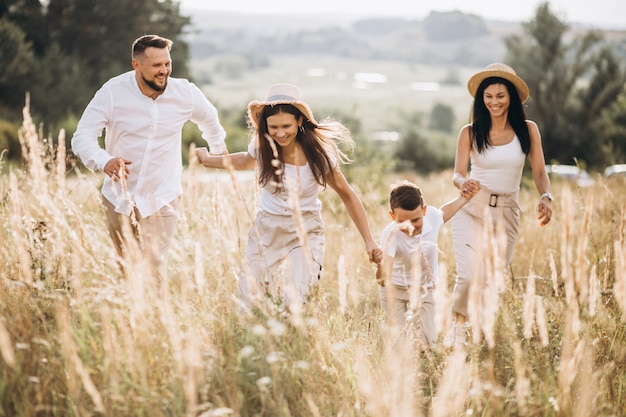 Parents with their children walking in field