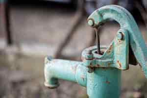 Free photo part old blue iron water tap stands outside