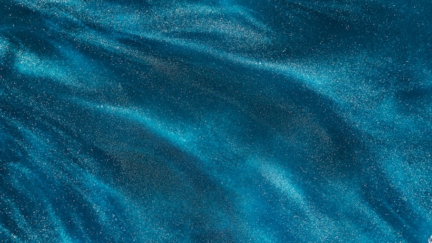 Particles of azure dye in water