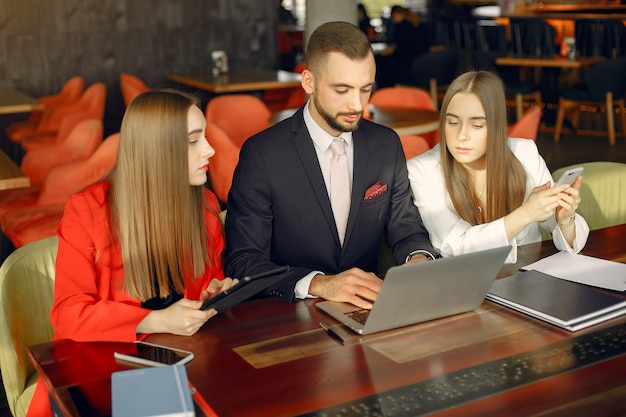 Partners sitting at the table and working in a cafe