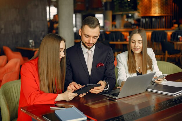 Partners sitting at the table and working in a cafe