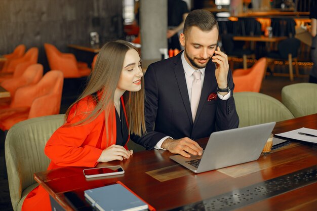 Partners sitting at the table and working in a cafe