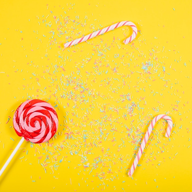 Free photo party composition with candy canes and lollipop