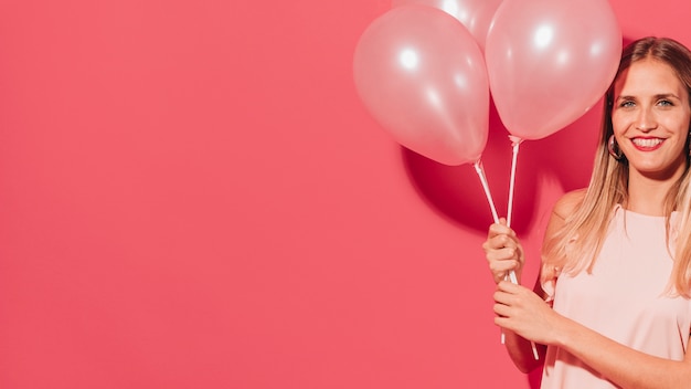 Free photo party girl posing with balloons