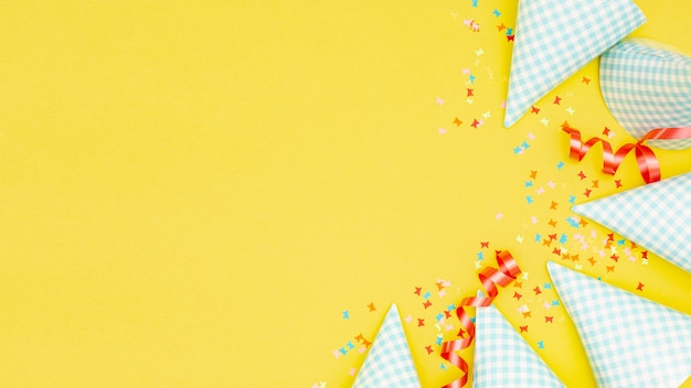 Party hats and confetti with copyspace