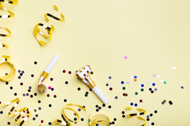 Party whistles and confetti with copy space