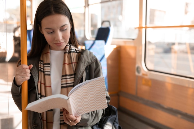 Free Photo passenger reading and travelling by tram