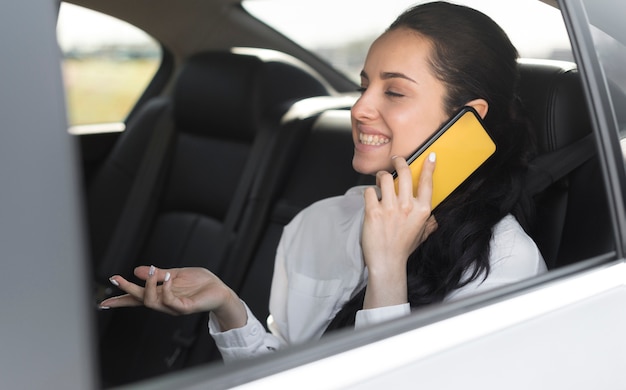 Passenger sitting in the car and talking on the phone