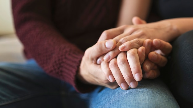 Passionate couple holding hands in bed