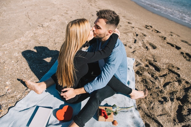 Free photo passionate couple kissing on beach