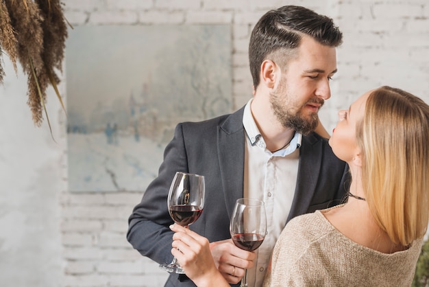 Free photo passionate young couple with wine