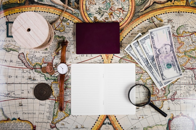 Passport and diary with antique equipments on world map