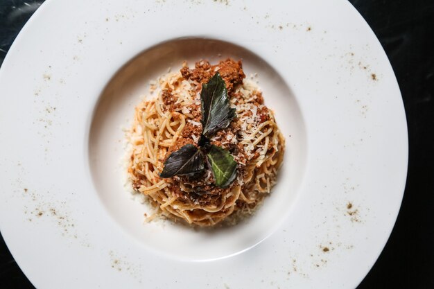 Pasta bolognese meat basil sumakh parmesan top view