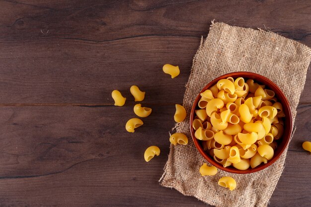 pasta in ceramic bowl on sackcloth