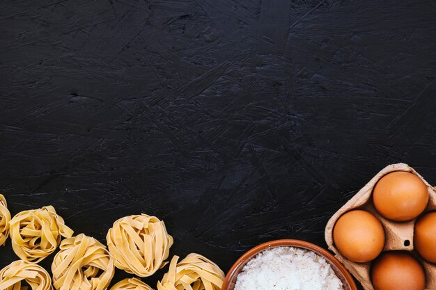 Pasta near flour and eggs